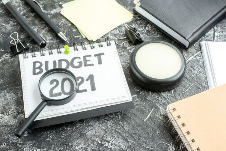 above view budget note with magnifier on dark background color c